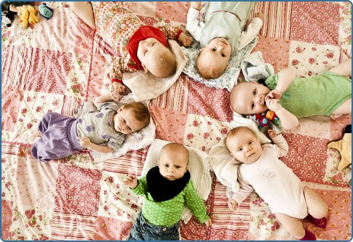 En lille flok babyer på et tæppe